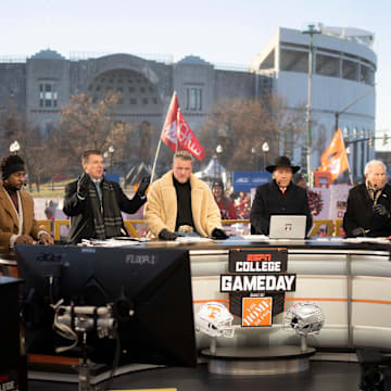 ESPN cast, from left, Desmond Howard, Rece Davis, Pat McAfee, Nick Saban, Lee Corso and Kirk Herbstreit sit on the set of College GameDay prior to the College Football Playoff first round game between the Ohio State Buckeyes and Tennessee Volunteers in Columbus on Dec. 21, 2024.